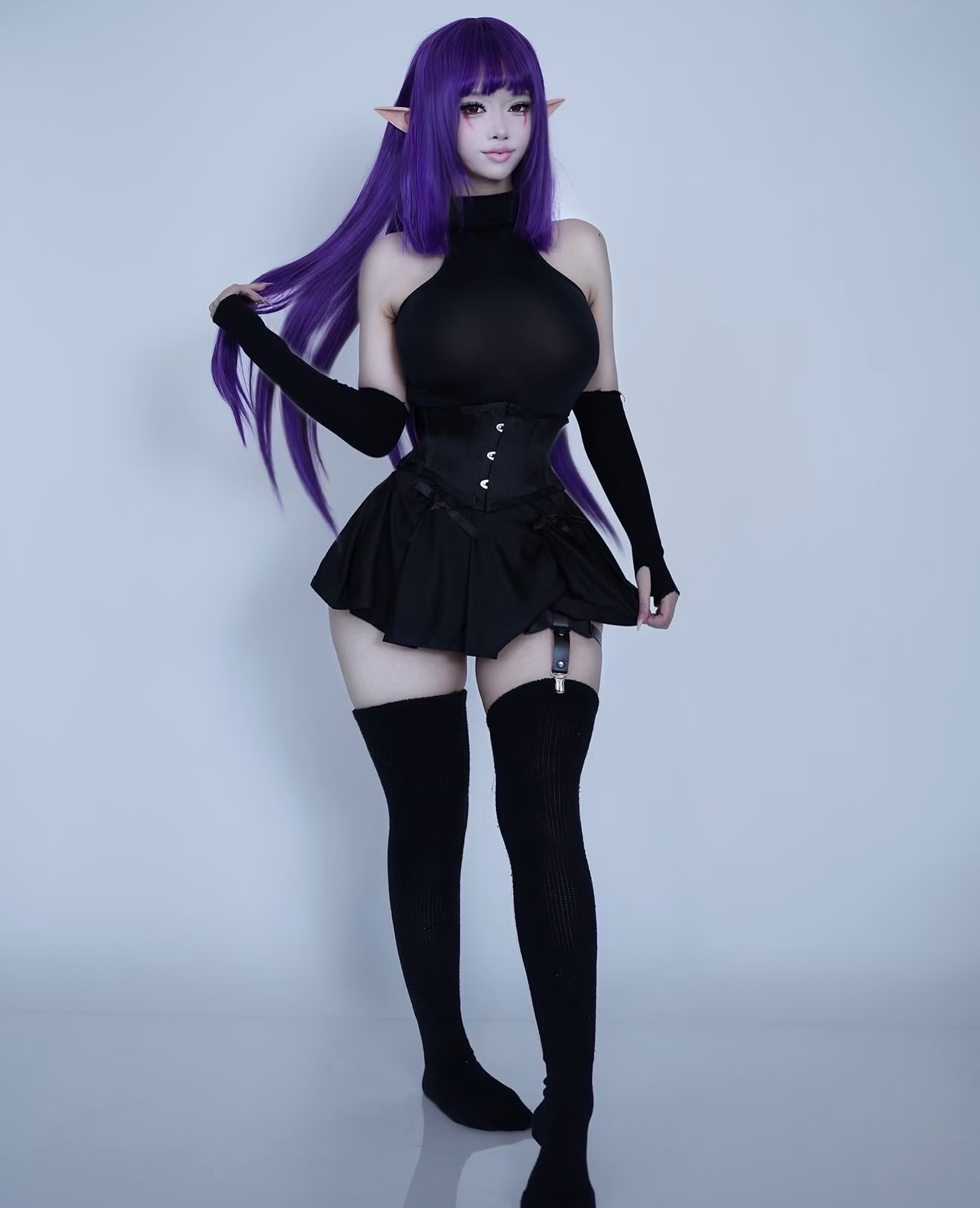 Ari in a purple wig and black cosplay outfit